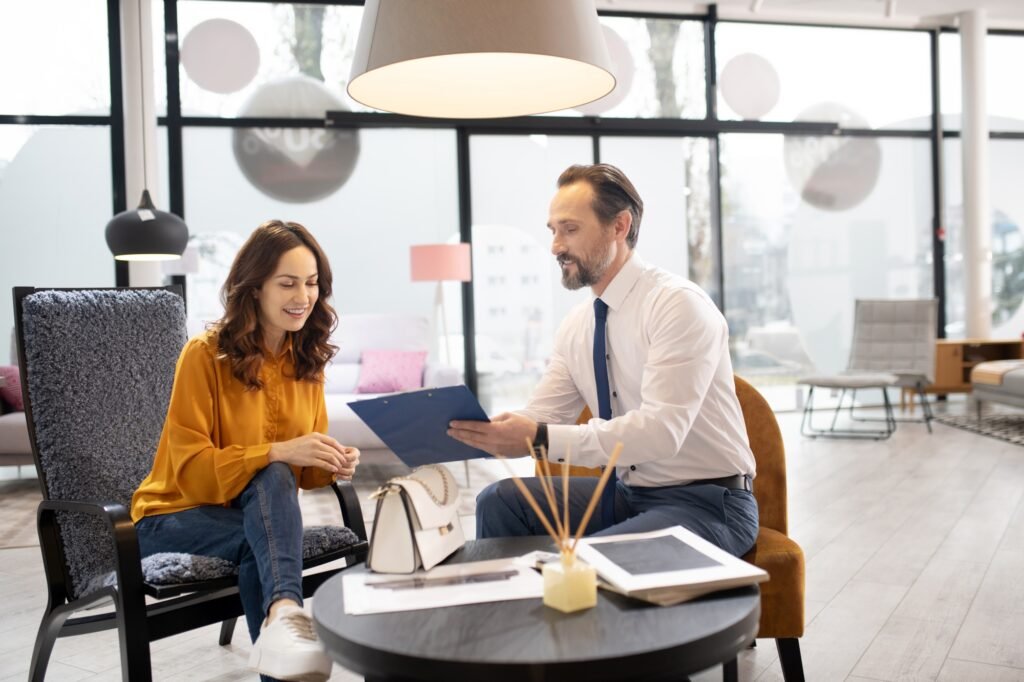 Furniture designer in tie and white shirt talking to the customer